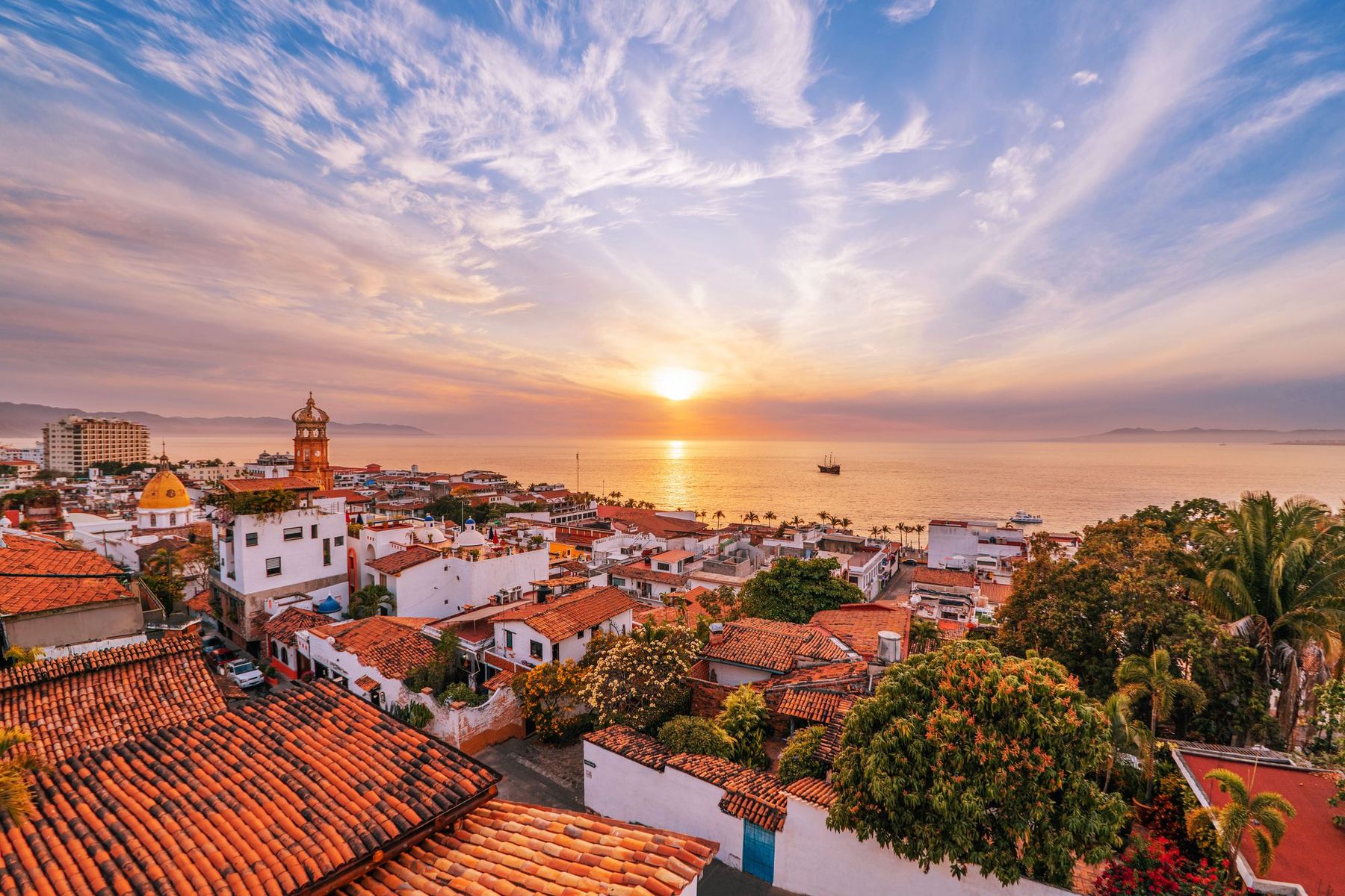 Sunset over the red rooftops of downtown Puerto Vallarta