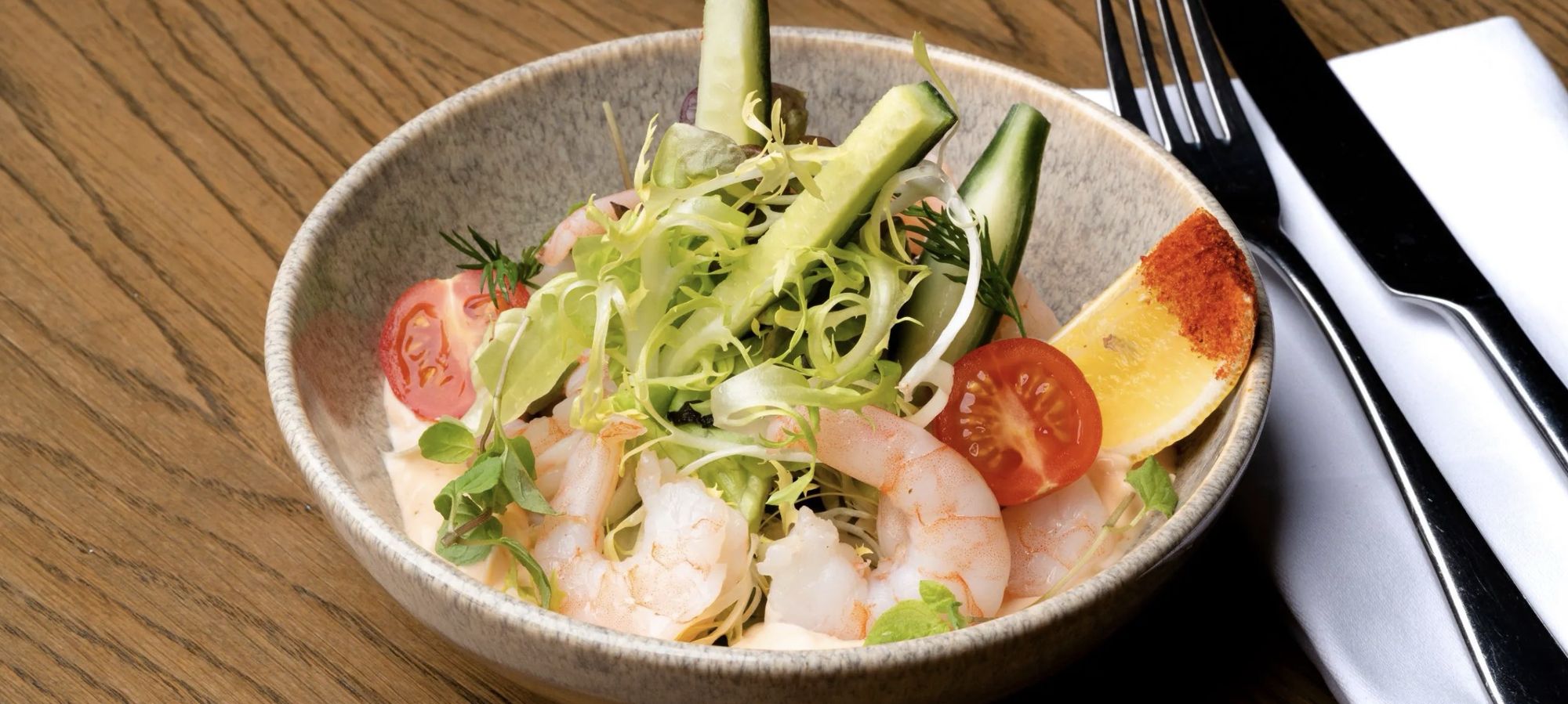 A prawn salad served in a stone bowl