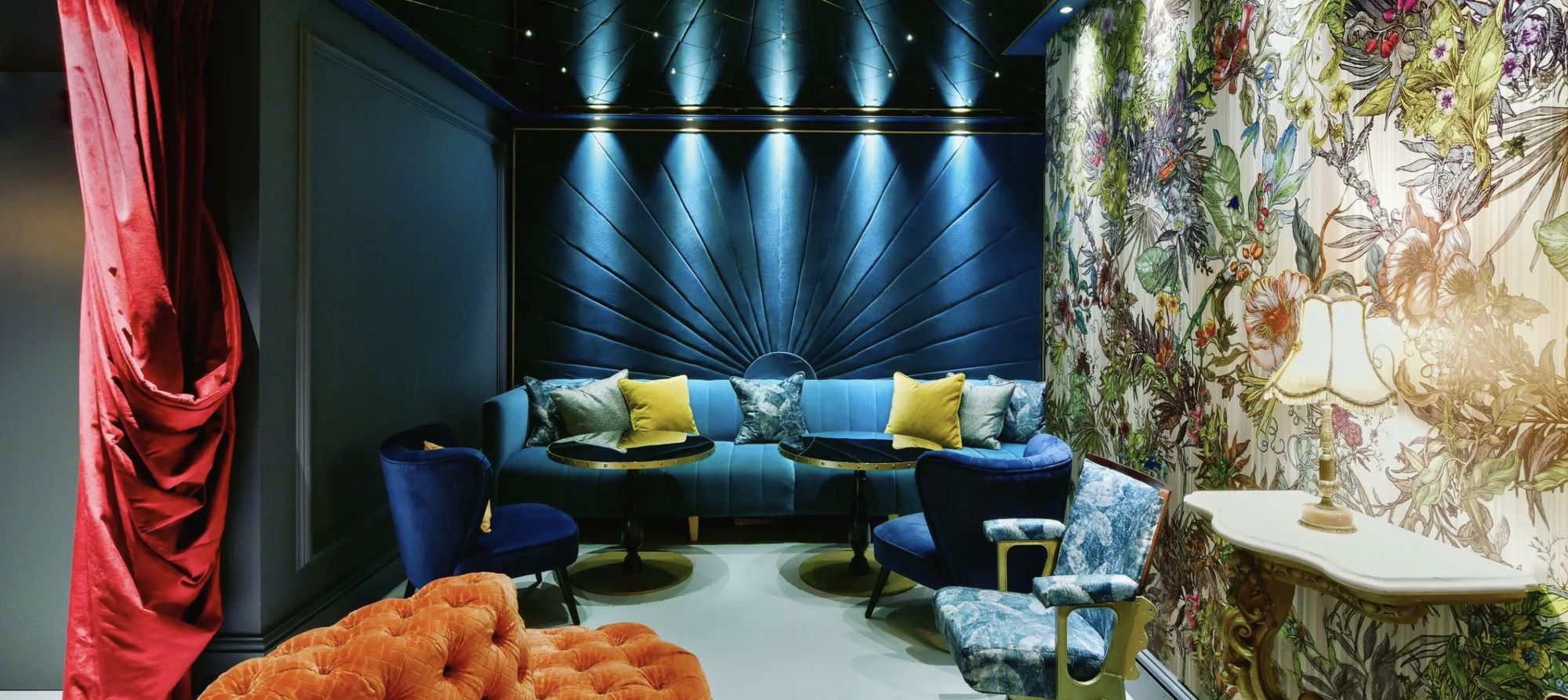 A moody blue lounge with patterned walls