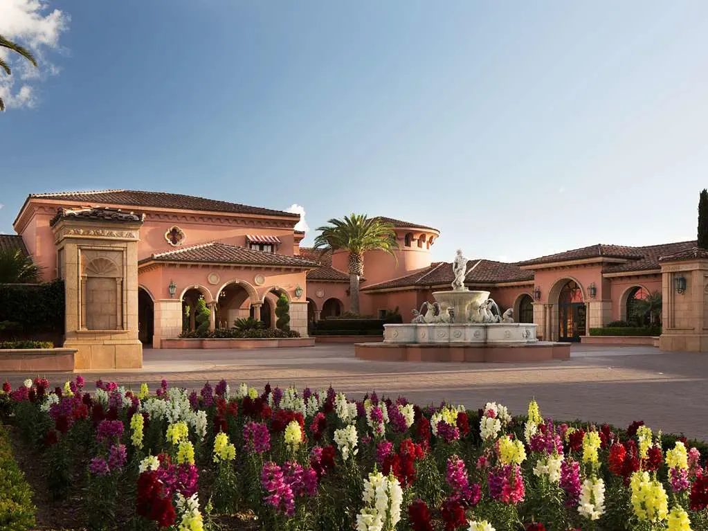 The entry court and fountain, with beds of snapdragons in front