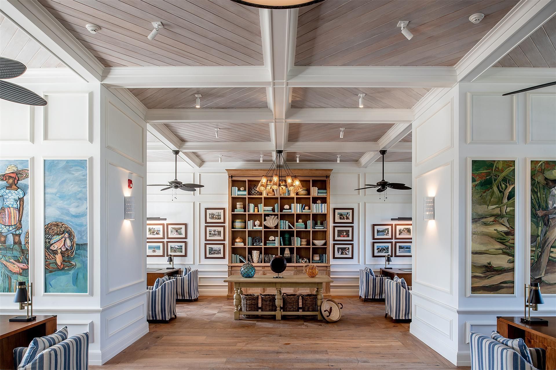 A library lounge with bookshelves and Caribbean art