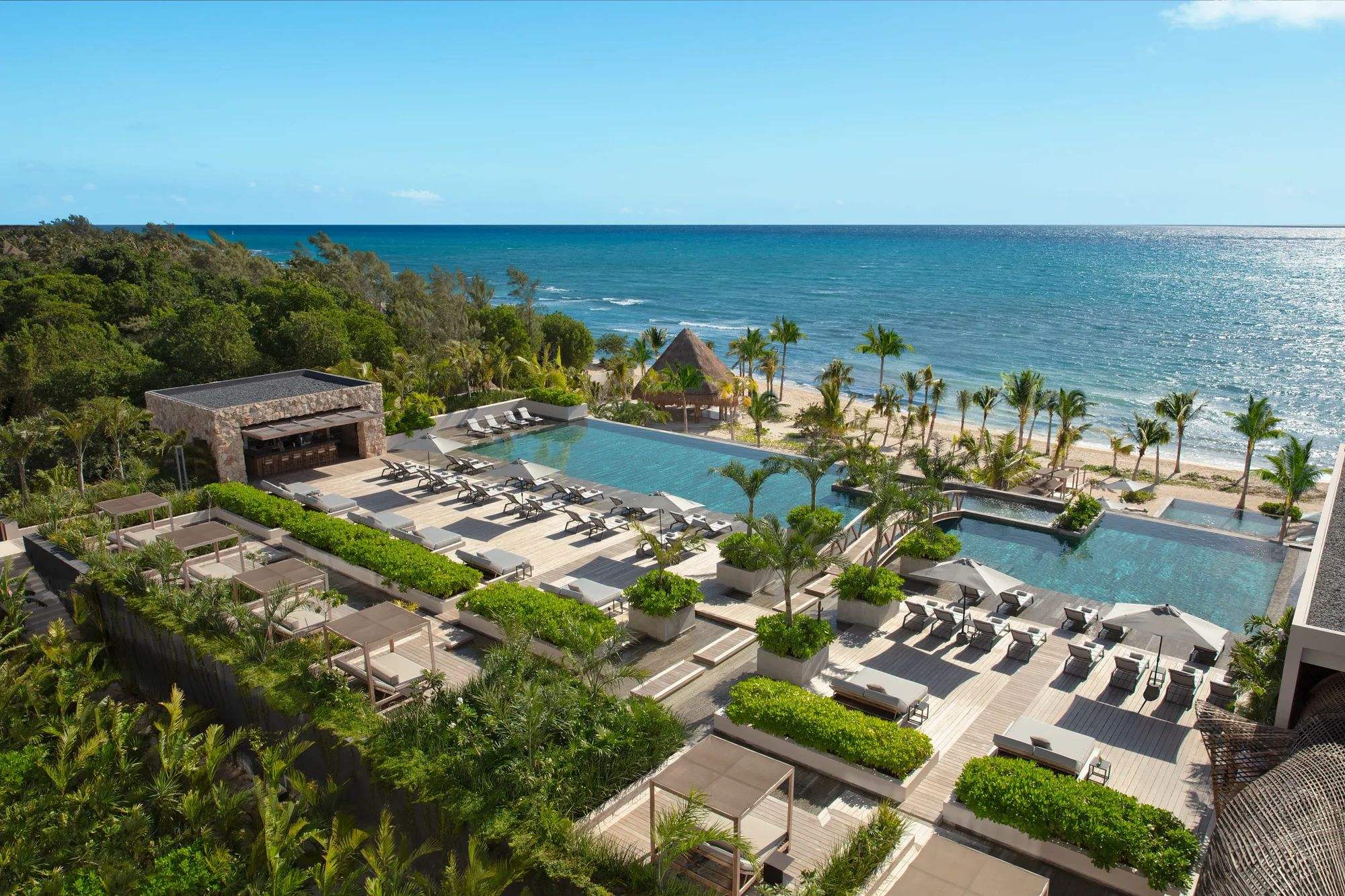Aerial view of the main pool and palapas running down to the Caribbean