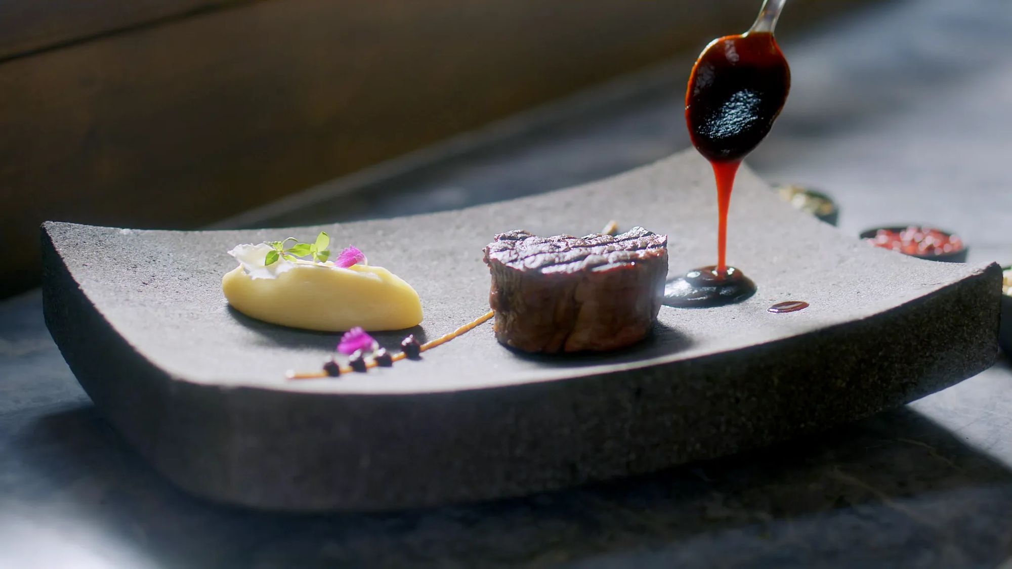 A plated course at Teodoro, finished with a pour of sauce