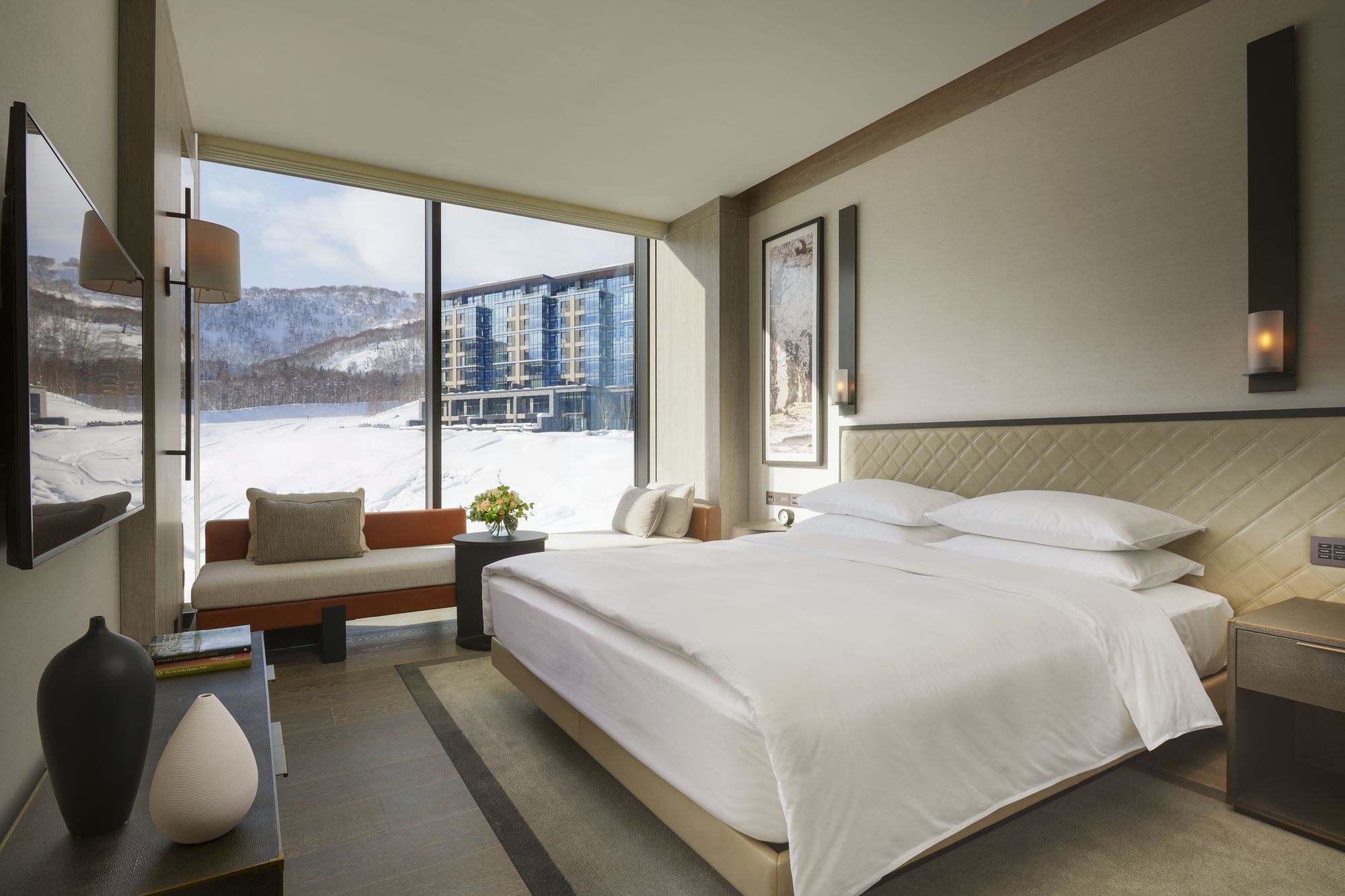 A king room with a wide window onto the mountain