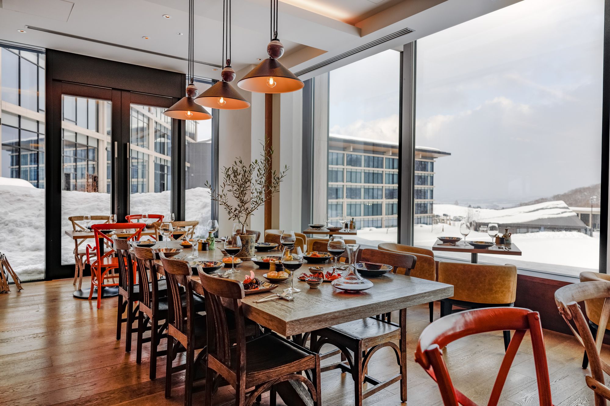 Olivio's dining room, with long tables and mountain views