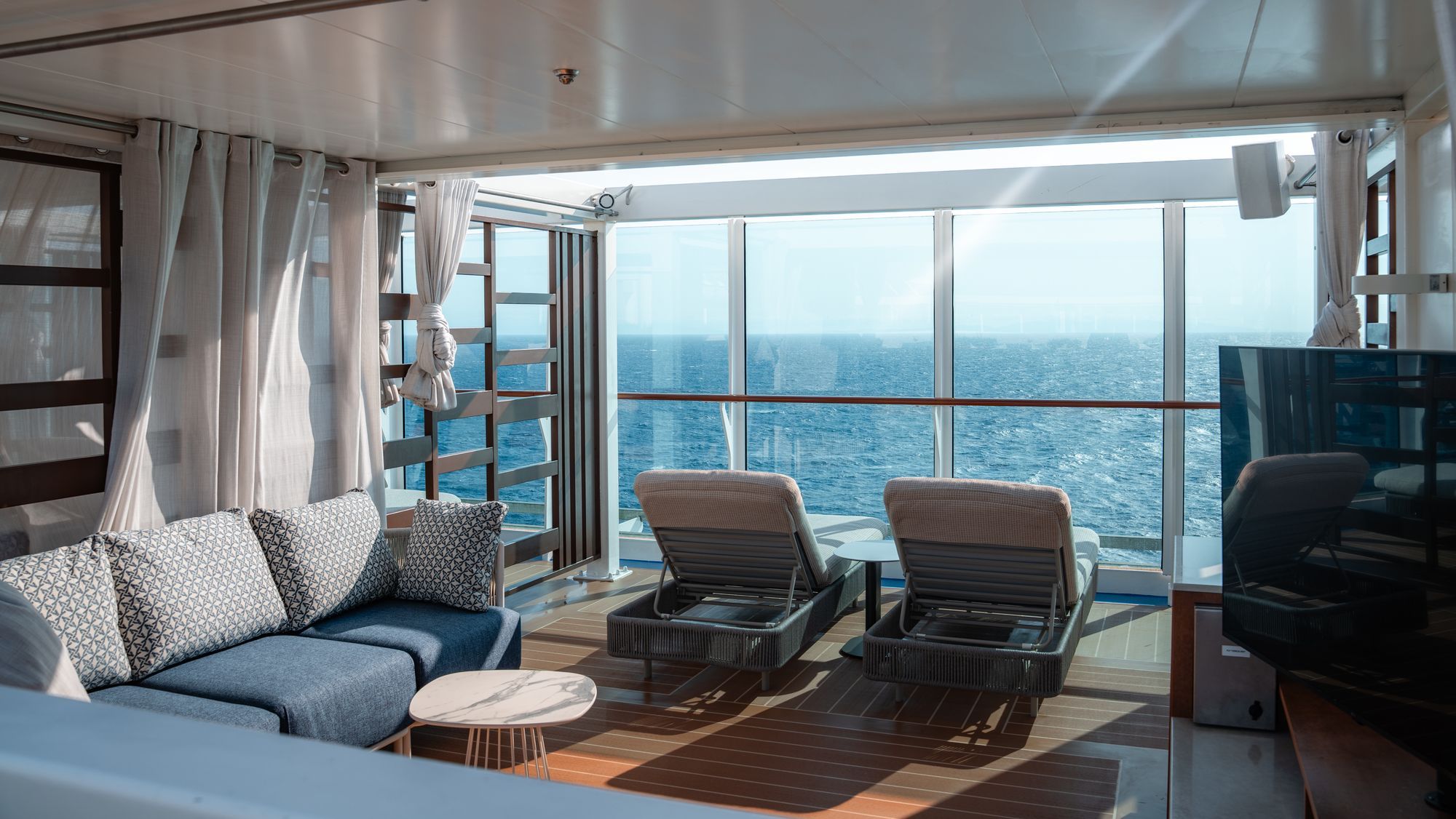 The Sanctuary, a quiet adults-only retreat aboard ship with loungers by the window