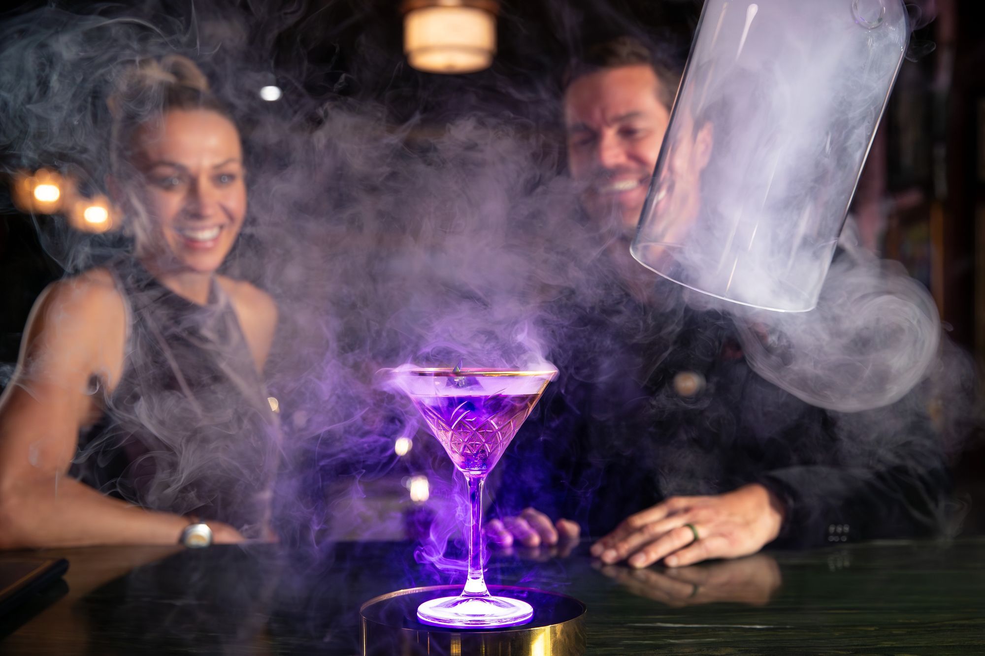A smoking violet cocktail served at Spellbound