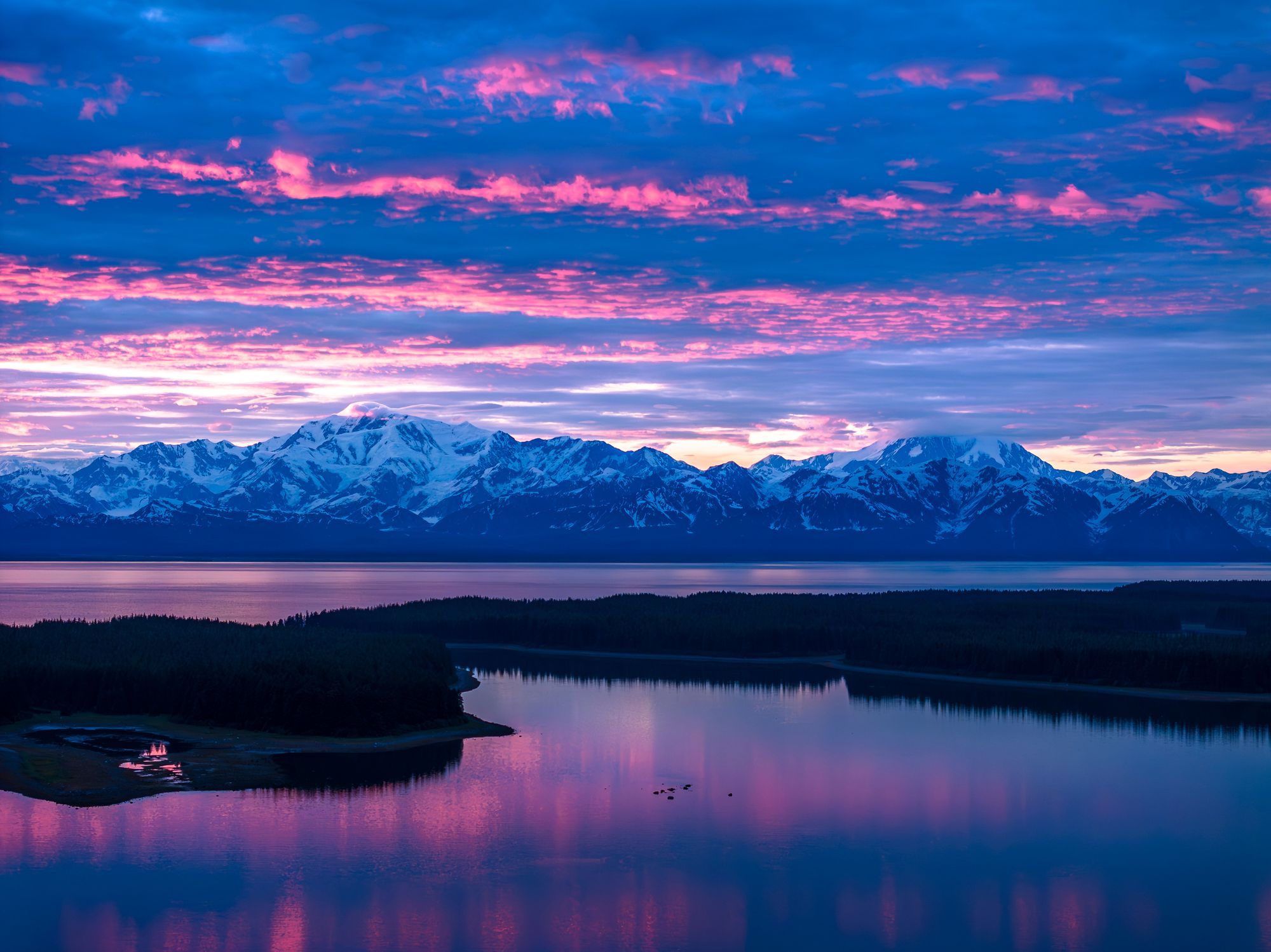 Pink and violet sunset over the mountains of Yakutat Bay