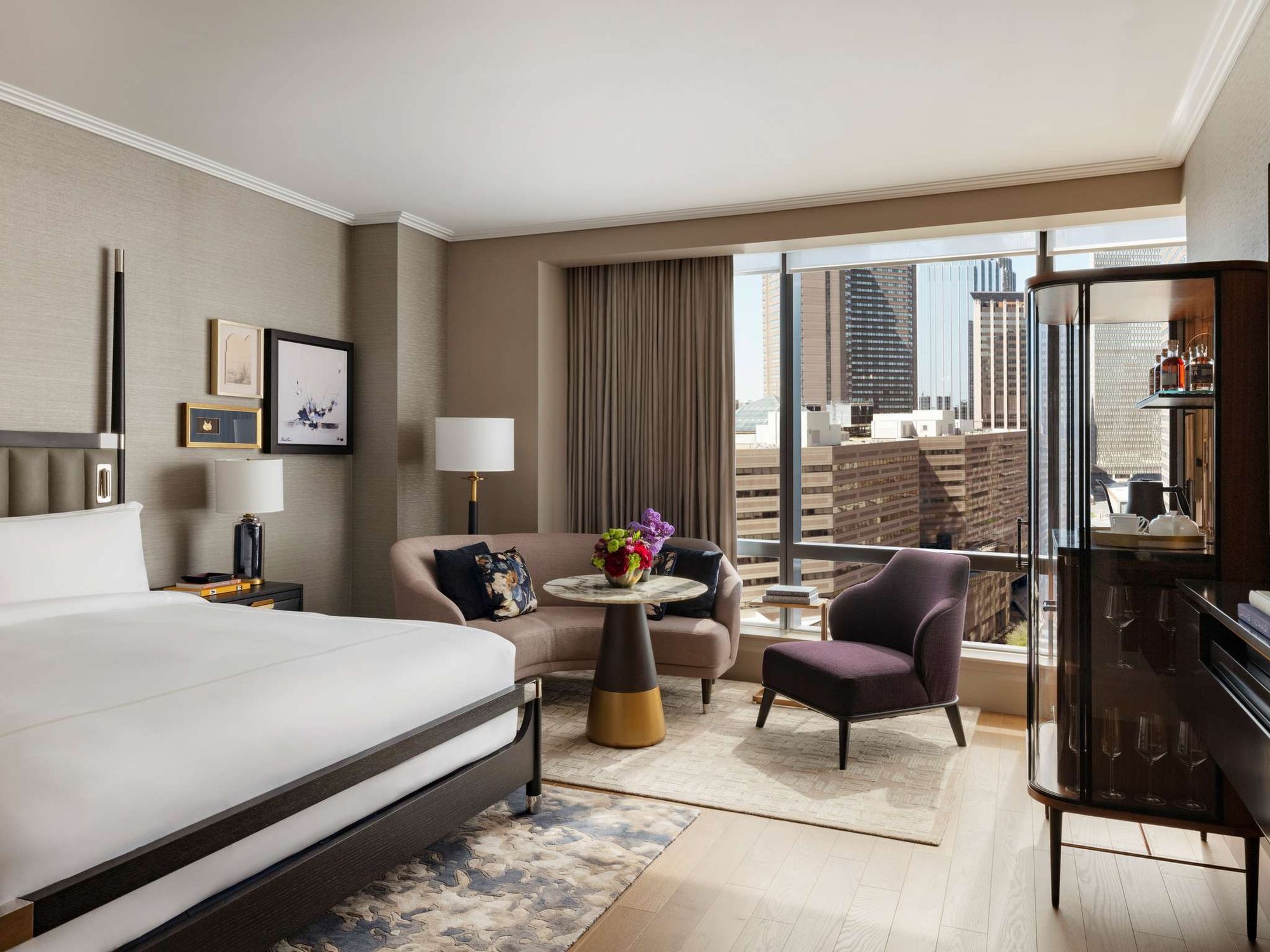 A guest room with a sitting area by the window