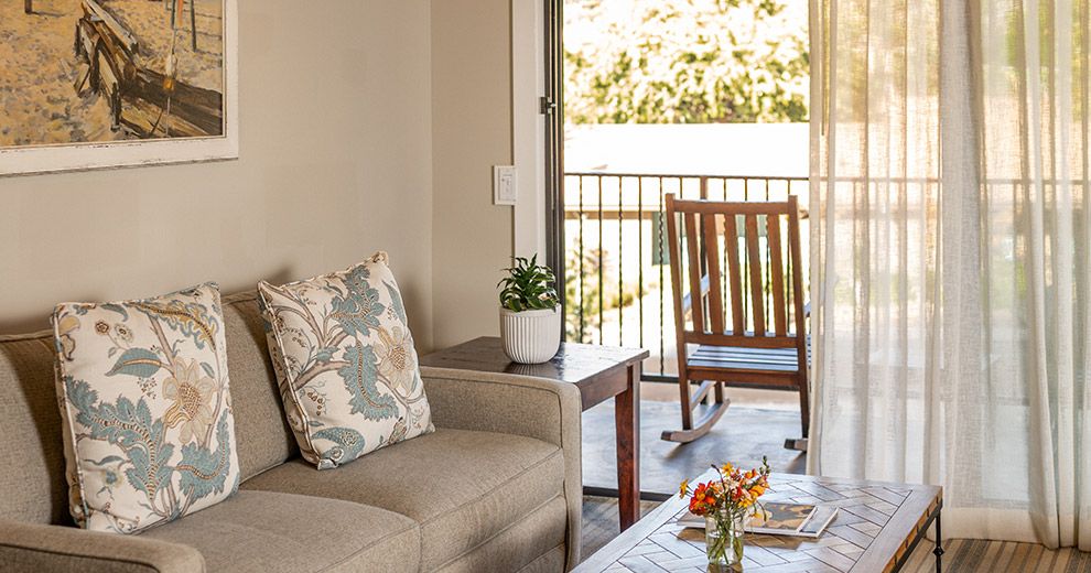 A sitting area with a rocking chair on the balcony