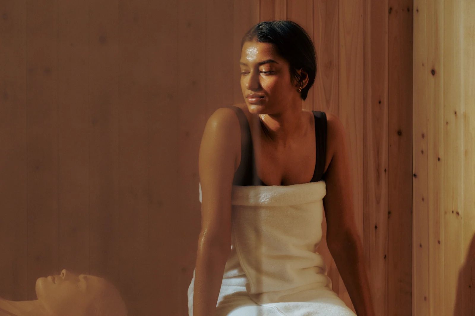 A guest relaxing in a cedar sauna