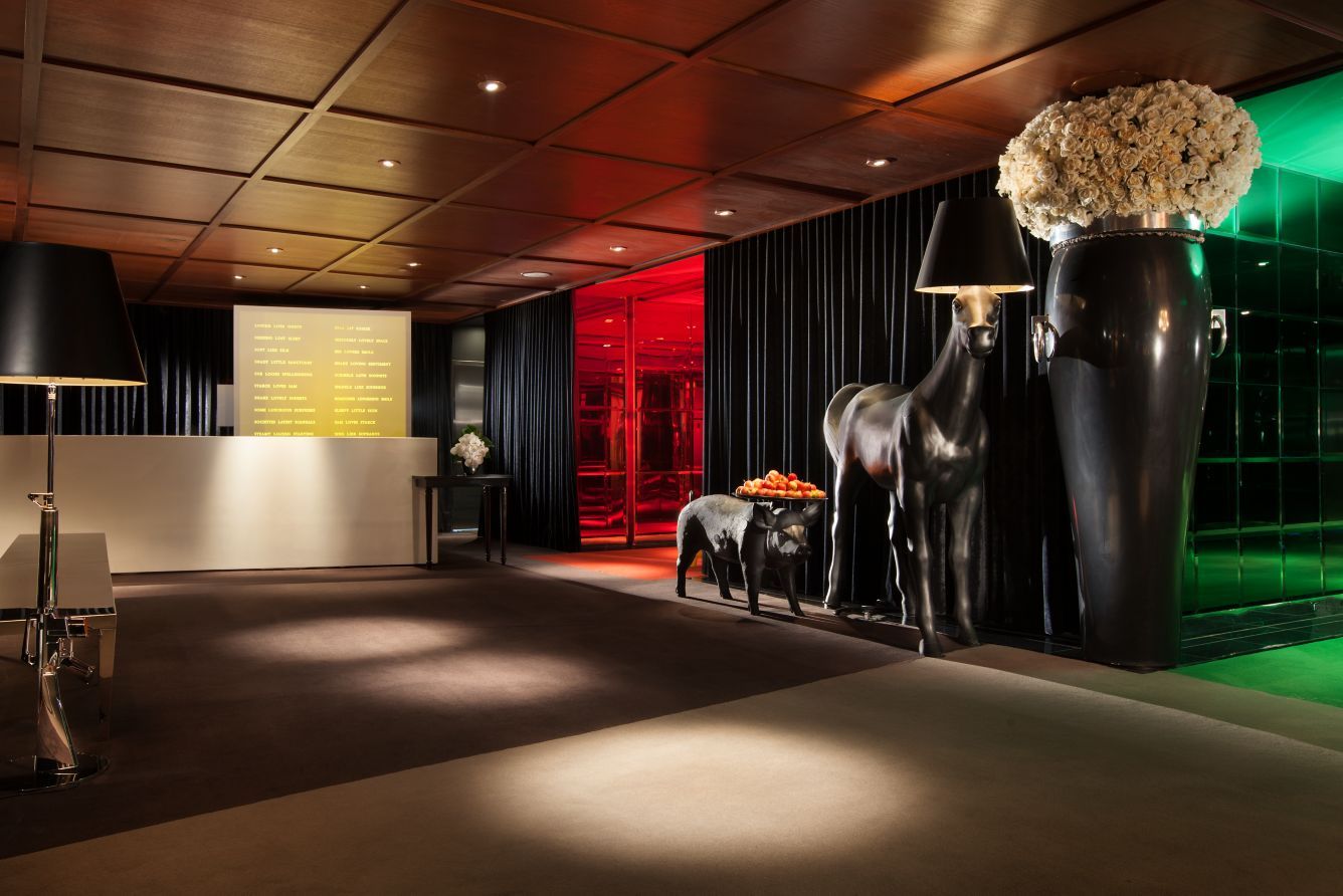 The front desk, with oversized horse sculptures and a vase of roses