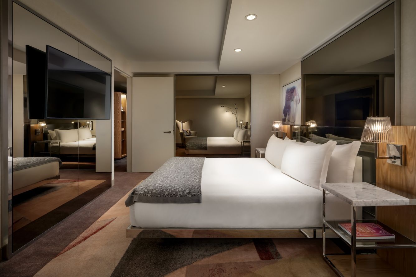 A king suite with a sitting area beyond the bed