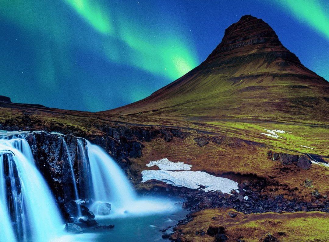 Northern lights over Kirkjufell mountain and a waterfall in Iceland