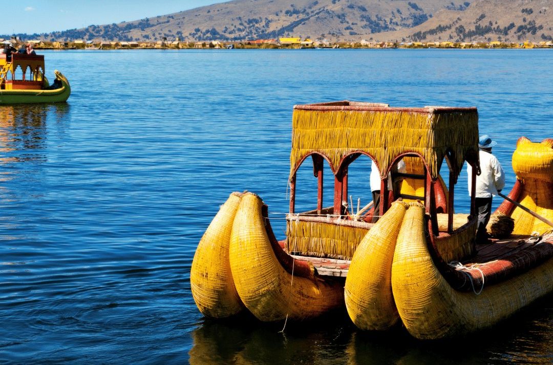 Traditional reed boats on Lake Titicaca under a bright sky