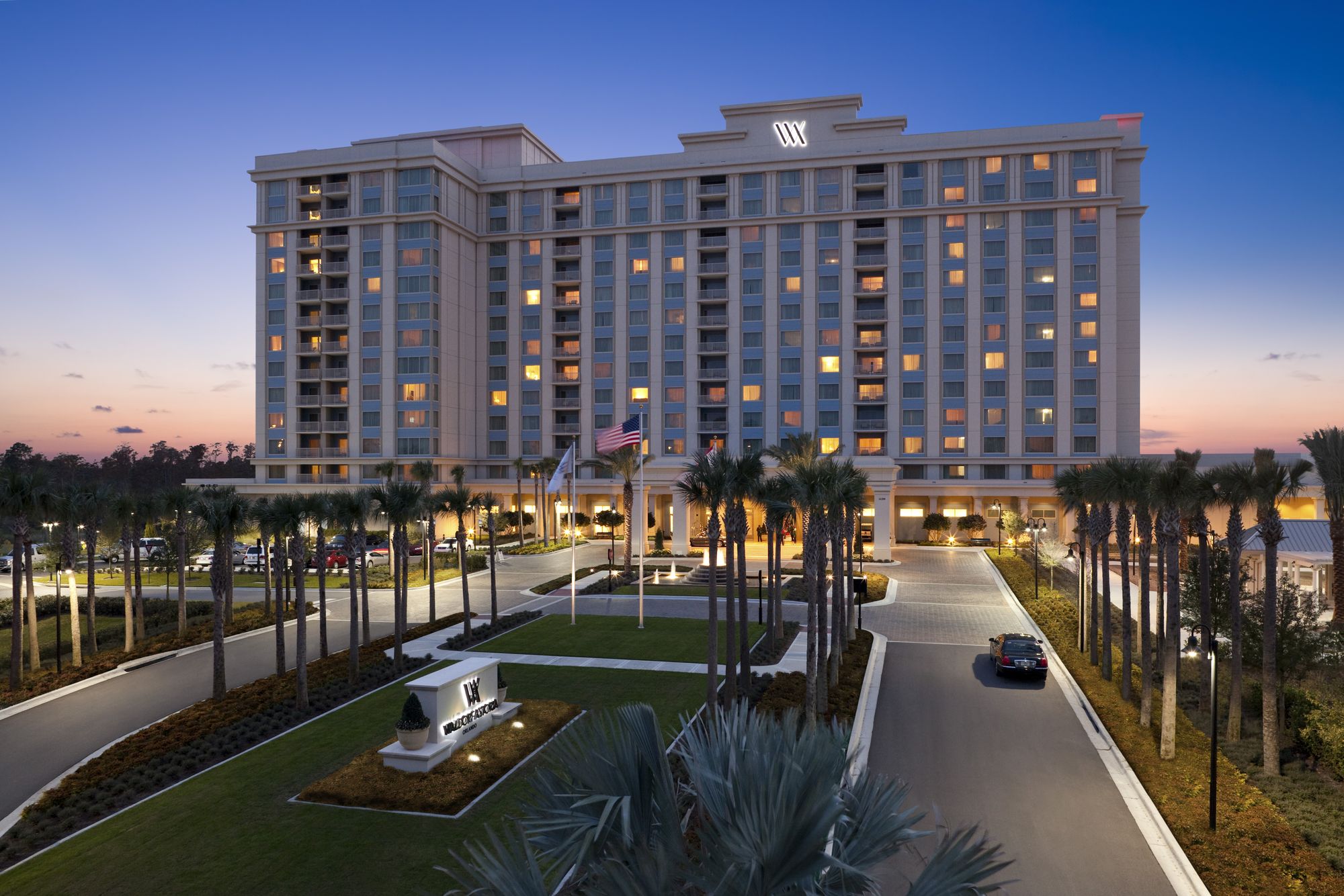 The hotel tower and entry drive at twilight